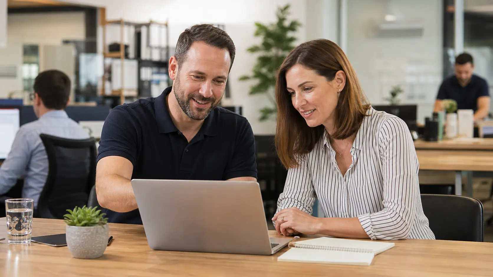 Small business owner reviewing onboarding notes with a technology adviser