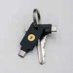 YubiKey 5C NFC and YubiKey 5Ci hardware security keys on a keyring, showing different connector designs
