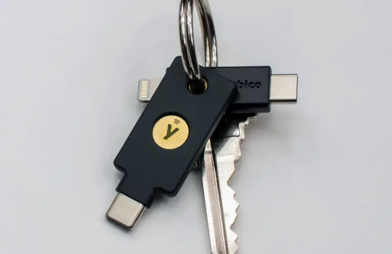 YubiKey 5C NFC and YubiKey 5Ci hardware security keys on a keyring, showing different connector designs
