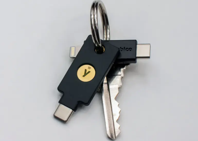 YubiKey 5C NFC and YubiKey 5Ci hardware security keys on a keyring, showing different connector designs