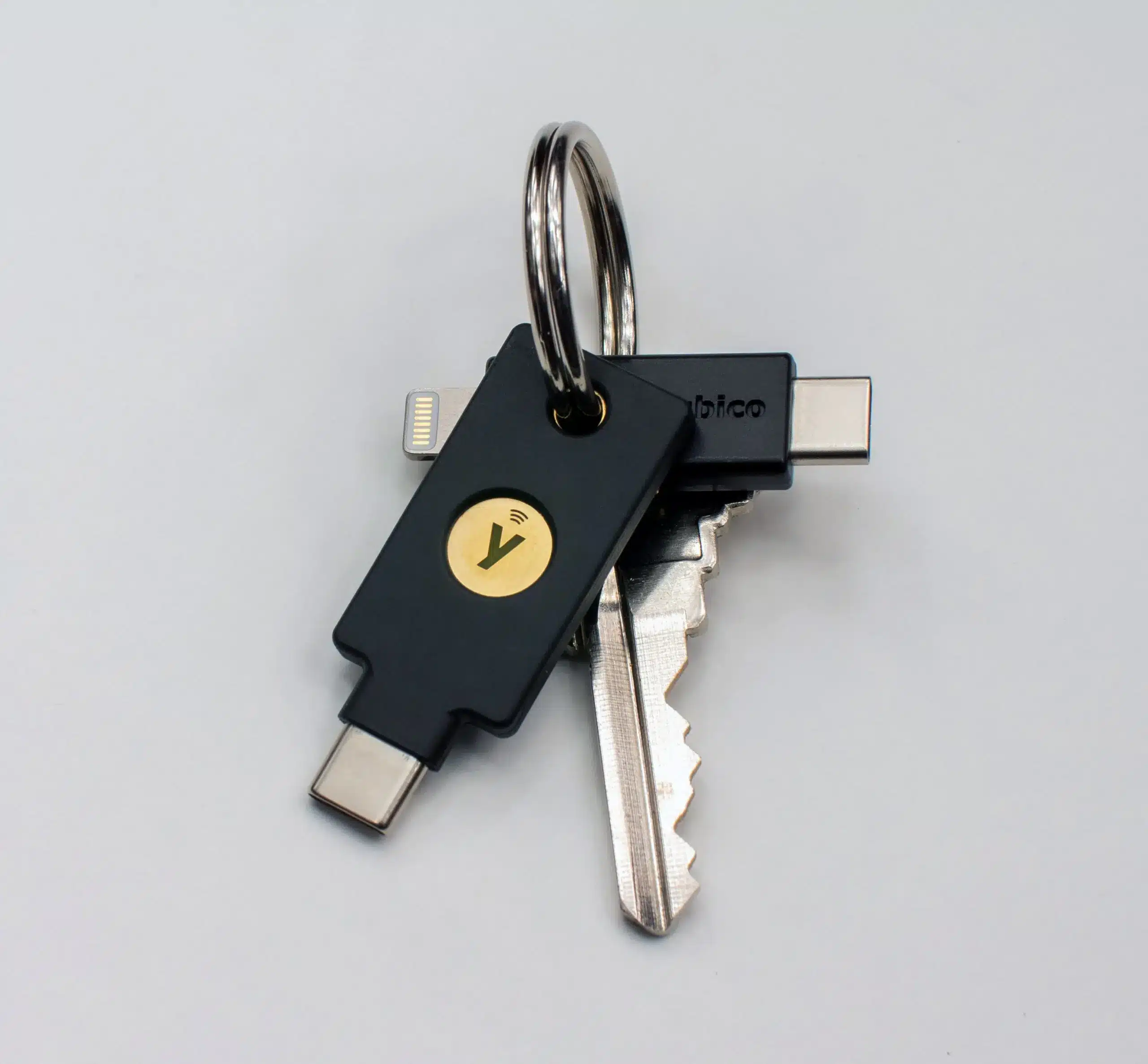 YubiKey 5C NFC and YubiKey 5Ci hardware security keys on a keyring, showing different connector designs