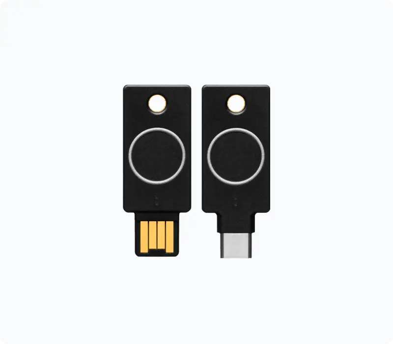 Two YubiKey Bio hardware security keys with fingerprint sensors, in USB-A and USB-C formats