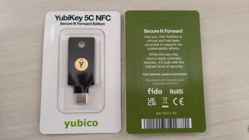 Front and back packaging of YubiKey 5C NFC Secure It Forward Edition, with a physical USB-C security key visible.