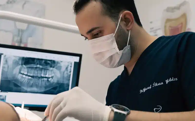 Dentist treating a patient in a modern clinic with diagnostic equipment