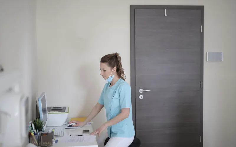 Doctor using a clinic computer at a modern medical workstation
