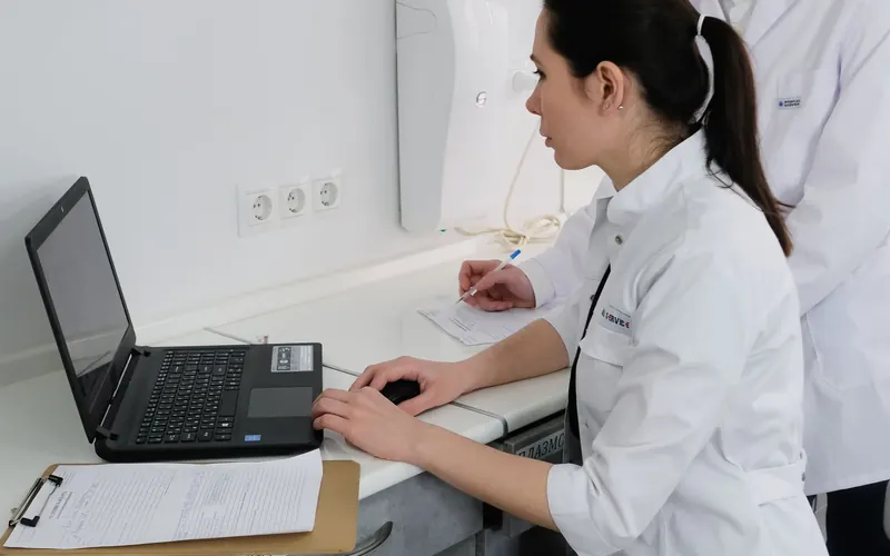 Medical professionals reviewing information together on a laptop