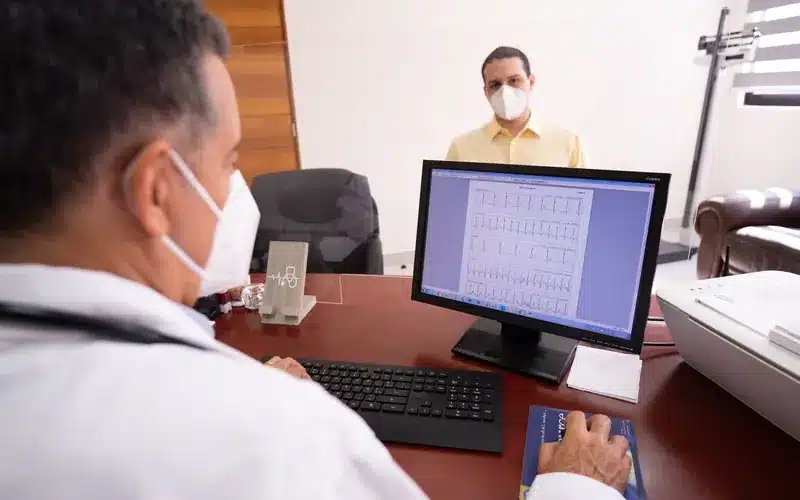 Doctor and patient reviewing information on a clinical computer